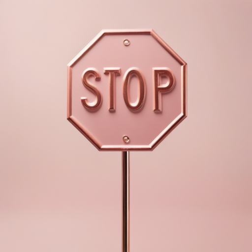 A rose gold stop sign stands against a pale pink backdrop.