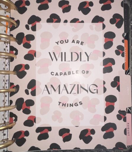 An image of a Happy Planner's monthly divider for July, adorned with an uplifting and motivational quote.