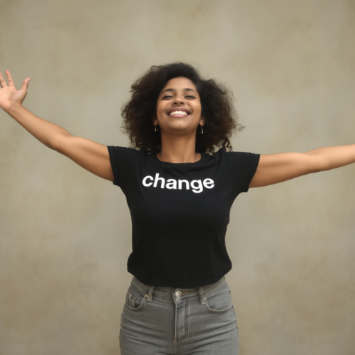 A black woman in her thirties is dressed in a short-sleeved t-shirt emblazoned with the word "change" in white letters. She extends her arms outward in a gesture of celebration, her eyes closed and a smile on her face. She's also clad in stonewashed grey jeans, set against a backdrop of muted taupe.